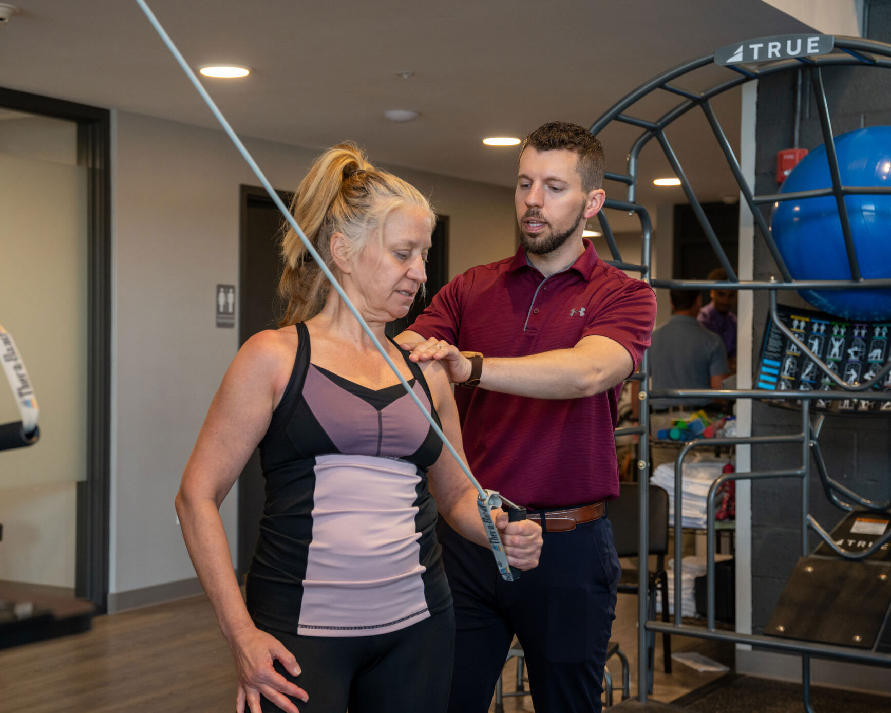 A Physical Therapist working on a shoulder patient.