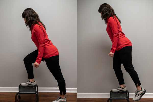 A Physical Therapist in a red sweatshirt demonstrates a squat.