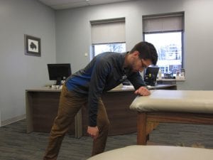image of a physical therapist doing a shoulder stretch