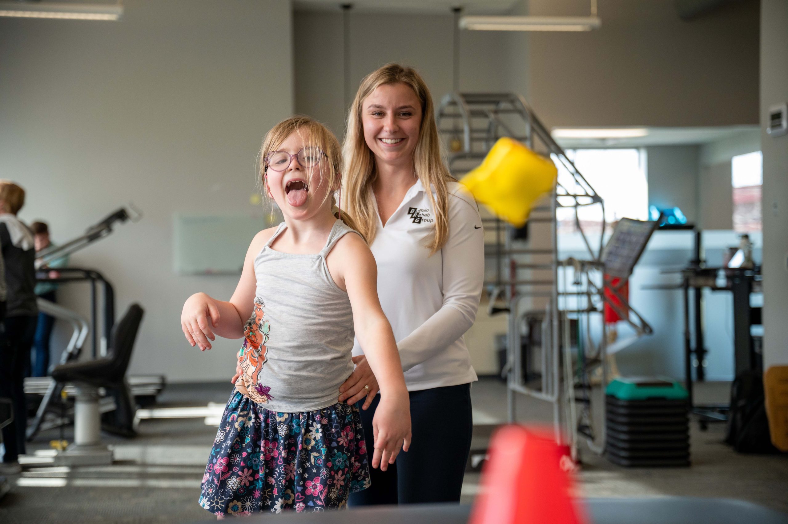 A Physical Therapist treats and injury on her patient's back, focusing intensely on the area.