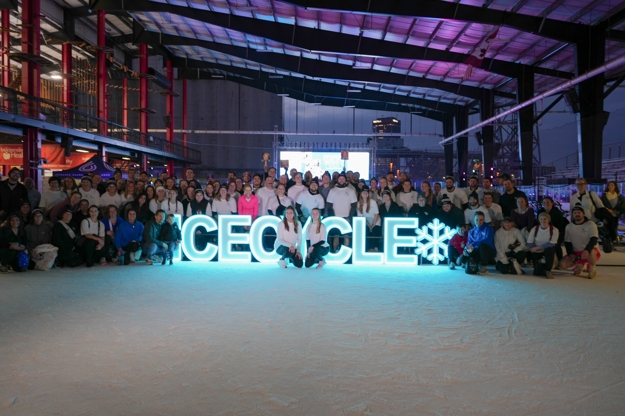 Teammates from Buffalo Rehab Group posing for a photo smiling in black team t-shirts at the 2025 JP Morgan Corporate Challenge.